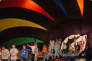 Students entering balloon during indoor inflation