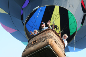 Passengers waving from basket